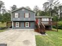 Two-story home with a gray exterior, brown shutters and trim, and front porch at 25 Stoneway Dr, Villa Rica, GA 30180