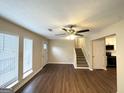 Bright living room with ceiling fan, hardwood floors, and staircase access at 25 Stoneway Dr, Villa Rica, GA 30180