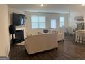 Open-concept living room with fireplace and comfortable seating, perfect for relaxation and entertaining at 11909 Lovejoy Crossing Blvd, Hampton, GA 30228