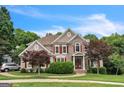 A stunning two-story home with a combination of stone and stucco, red shutters, and a well-maintained lawn at 2693 Blairsden Nw Pl, Kennesaw, GA 30144