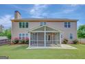 Spacious backyard featuring a screened porch perfect for outdoor relaxation, complemented by lush green grass at 340 Aster Ridge Trl, Peachtree City, GA 30269