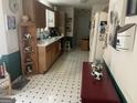 Galley kitchen with white countertop, cabinetry, and contrasting flooring at 248 Fern Ct, Hampton, GA 30228