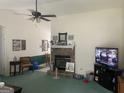 Spacious living room with fireplace, ceiling fan and backyard views at 248 Fern Ct, Hampton, GA 30228