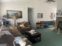 Cozy living room featuring fireplace, ceiling fan, and comfortable seating at 248 Fern Ct, Hampton, GA 30228