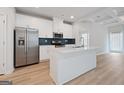Bright kitchen with island, stainless steel appliances, white cabinets, and an open layout to living areas at 4003 Garden Ln, College Park, GA 30337