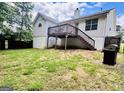 The backyard features a deck with stairs, a grill, and a partially grassy area at 1741 Portwest Way, Hampton, GA 30228