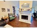Cozy living room featuring a fireplace, bookshelf, and comfortable seating at 1741 Portwest Way, Hampton, GA 30228