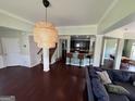 Open-concept foyer with dark hardwood floors, seamlessly connecting to the kitchen and living areas at 1369 Star Water Dr, Lawrenceville, GA 30045