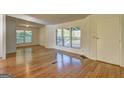 Inviting living room showcasing beautiful hardwood floors and large windows at 50 Caroline Ave, Stockbridge, GA 30281