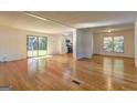 Spacious living room featuring gleaming hardwood floors and ample natural light at 50 Caroline Ave, Stockbridge, GA 30281