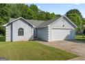 Charming single-story home featuring a two-car garage and well-maintained lawn at 135 Gingercake Ct, Fayetteville, GA 30214