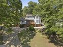 Two-story home with a front yard surrounded by trees at 6942 Cottonwood Trl, Riverdale, GA 30296