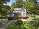 Charming two-story home with a wooden porch and a well-maintained front yard at 6942 Cottonwood Trl, Riverdale, GA 30296