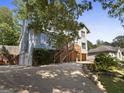 Two-story home with a wooden porch and a long driveway at 6942 Cottonwood Trl, Riverdale, GA 30296