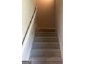 Carpeted stairs with white trim, perfect for a cozy and quiet climb to the next level at 1151 Park Center Nw Cir, Austell, GA 30168