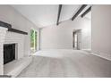 Spacious living room with a white painted brick fireplace and access to the backyard at 9438 Cedar Creek Pl, Douglasville, GA 30135