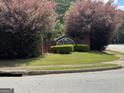 Landscaped entrance sign to Oak Hill community adds curb appeal and defines the residential area at 85 Creekside Trl, Covington, GA 30016