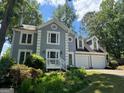 Charming two-story home featuring a spacious two-car garage, front porch, and landscaped front yard at 4080 Longford Ne Dr, Marietta, GA 30066