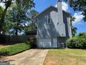Side view of the charming home with a one-car garage and spacious lawn at 4080 Longford Ne Dr, Marietta, GA 30066