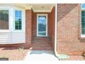 Close-up of the front entrance, showcasing the brick facade and glass-paneled door at 3533 Saddlebrook Dr, Loganville, GA 30052