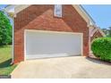 Attached garage with a clean, white door and spacious driveway at 3533 Saddlebrook Dr, Loganville, GA 30052