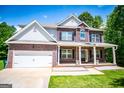 Charming two-story brick home with covered porch and well-manicured lawn at 137 River Birch Dr, Carrollton, GA 30116