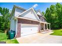 Charming two-story brick home with covered porch and well-manicured lawn at 137 River Birch Dr, Carrollton, GA 30116