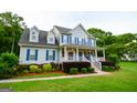 Beautiful two-story home featuring blue shutters and a charming front porch at 855 Hood Rd, Fayetteville, GA 30214