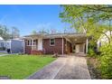 Inviting brick home with a long driveway and a convenient carport at 338 Mount Zion Rd, Hapeville, GA 30354