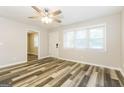 Bright living room featuring stylish flooring, a ceiling fan and natural light at 338 Mount Zion Rd, Hapeville, GA 30354