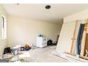 Spacious room under renovation, featuring a window and a white vintage stove at 8005 Big Rock Dr, Douglasville, GA 30134