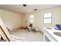 Room under renovation with an open view to the door and a vintage white stove at 8005 Big Rock Dr, Douglasville, GA 30134