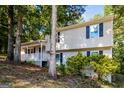 Two-story home with white siding, dark shutters, and a cozy, covered front porch at 2730 Pine Log Way, Buford, GA 30519
