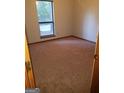 Bedroom with neutral carpet, a large window providing natural light, and freshly painted walls at 3208 Berrong Way, Stone Mountain, GA 30087