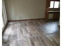 Open floor plan with hardwood floors leading to a kitchen and sliding glass doors to the exterior at 3208 Berrong Way, Stone Mountain, GA 30087