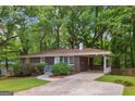 Beautiful brick home with a well-kept yard, mature trees, and convenient covered parking at 1749 Creat Se Trl, Smyrna, GA 30080