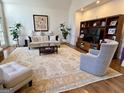 Bright living room features a cozy seating area, a stone fireplace, and an elegant area rug at 4710 Kinsmon Pl, Marietta, GA 30062
