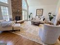 Spacious living room with a stone fireplace and large windows at 4710 Kinsmon Pl, Marietta, GA 30062