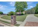 A long, paved driveway leads up to a stately brick home with lush green landscaping at 105 New Castle Ln, Tyrone, GA 30290
