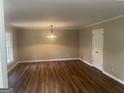 Bright living room featuring beautiful hardwood floors and modern lighting fixtures at 780 Sweet Briar Se Trl, Conyers, GA 30094