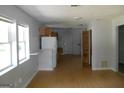 Spacious living room with light wood floors and natural light, transitioning into the kitchen area at 1391 Peachcrest Rd, Decatur, GA 30032