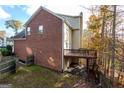 Brick two-story home featuring a back deck overlooking a wooded lot with backyard fencing at 345 Manning Ct, South Fulton, GA 30349