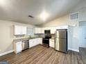 Well-equipped kitchen featuring white cabinets, granite countertops, and stainless steel appliances at 221 Courthouse Park Dr, Temple, GA 30179