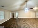 Spacious living room boasts vaulted ceilings, wood-look floors, and abundant natural light at 221 Courthouse Park Dr, Temple, GA 30179