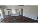 Open-concept living space featuring a central island with a marble countertop and modern wooden floors at 1378 Gus Thornhill Jr Dr, East Point, GA 30344
