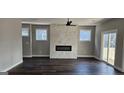 Inviting living room featuring a fireplace and windows that bring in natural light and warm wooden floors at 1378 Gus Thornhill Jr Dr, East Point, GA 30344