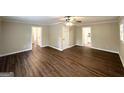 Spacious living room with wood flooring, neutral walls, and doorway view to kitchen at 1814 Mary Lou Se Ln, Atlanta, GA 30316