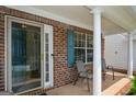 Covered front porch with brick detail, white columns, and seating area at 4511 Ravenwood Pl # 70, Union City, GA 30291