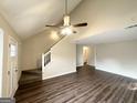 Open concept living room with hardwood floors, staircase and neutral paint colors at 6861 John Clark Dr, Douglasville, GA 30134