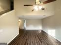 Spacious living room featuring wood floors, high ceilings and neutral paint colors at 6861 John Clark Dr, Douglasville, GA 30134